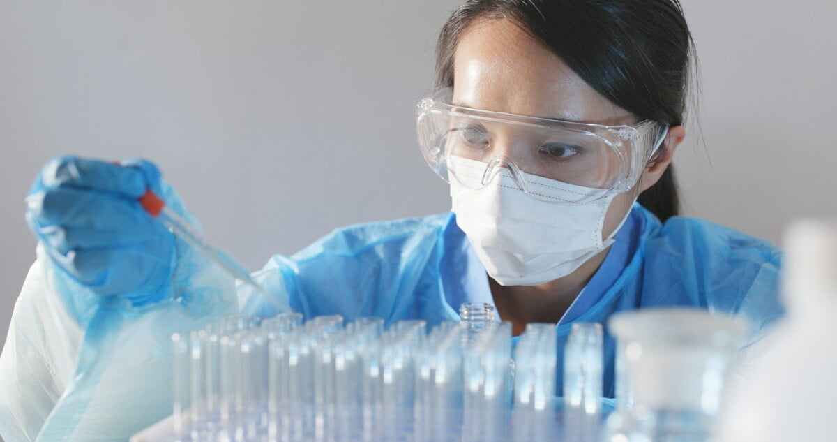 Scientist with a pipette analyzes Scientist with a pipette analyzes