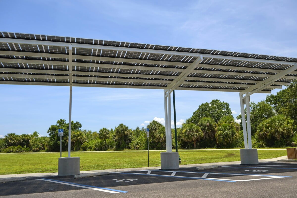 Solar panels installed over parking lot canopy shade for parked cars