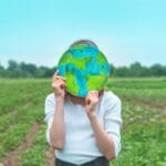 girl holding drawn planet in hands